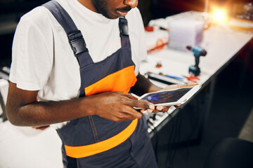 Wall Mural - african factory worker using tablet