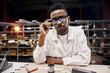 © sata_production - Serious african engineer working at factory