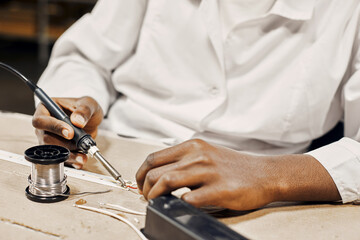 Wall Mural - man soldering led lamps with tools