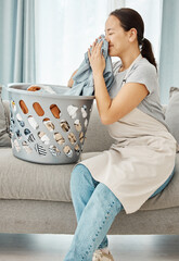 Poster - Clean laundry, happy woman and smelling fabric, fresh scent of clothes and washing basket of linen textile at home. Young, smile and asian person, housekeeping service and domestic cleaning lifestyle