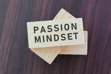 Wall Mural - Passion mindset word on wooden block with wooden background.