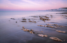 Purple Lilac Morning Blue Hour Sky And September Full Moon Setting During Low Tide At Birling Gap And The Seven Sisters On The East Sussex Coast South East England UK