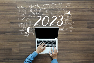 Wall Mural - Business plan 2023 new year ideas concept, Working on laptop with creative thinking drawing charts and graphs strategy