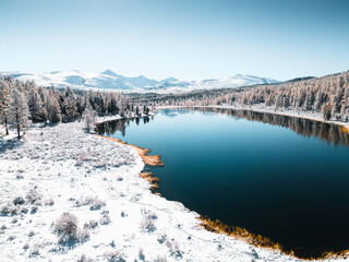 Wall Mural - Kidelu lake in Altai mountains, Siberia, Russia. Snow-covered trees and mountains.