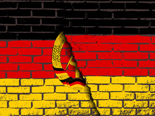 Wall Mural - a destroyed brick wall with the flag of Germany on top of the flag of the GDR