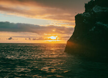 Sunset Over The Atlantic Ocean From The Portuguese Azores Islands. A Choppy Coast Line During Sunset Featuring Rocky Outcrops And An Amazing Sunset.