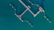 © Darunrat - Aerial top view oil terminal station platform with loading arm pipe line on deep seaport, Oil storage terminal port.