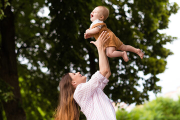 Sticker - Photo of adorable charming mom small daughter wear casual outfits playing throwing arms walking outside garden