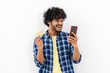 © kucherav - Cheerful young Asian man holding mobile phone and gold credit card standing on white background, online shopping concept, smiling