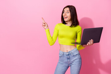 Wall Mural - photo of charming excited girl dressed lime shirt holding modern device looking pointing empty space