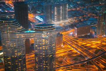 Wall Mural - Aerial Bird's-eye View Of Dubai Cityscape Skyline. Night Traffic In Residential District. Street Night Yellow Illumination In Dubai. Cityscape background of Dubai, UAE, United Arab Emirates. High