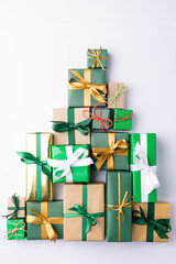 image of christmas gifts forming christmas tree and copy space on grey background