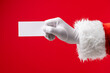 © vectorfusionart - Image of hand of santa claus holding white card with copy space on red background