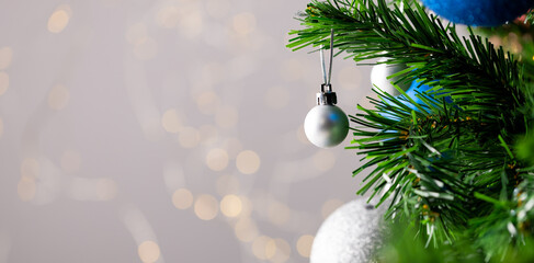 image of christmas tree with baubles decoration and copy space on grey background