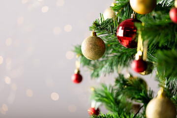 image of christmas tree with baubles decoration and copy space on grey background