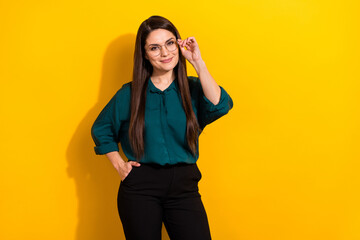 Wall Mural - Photo of smart clever lady dressed green shirt arm glasses smiling empty space isolated yellow color background