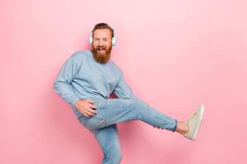 Wall Mural - Profile portrait of overjoyed cheerful man listen new playlist hands hold leg play guitar isolated on pink color background