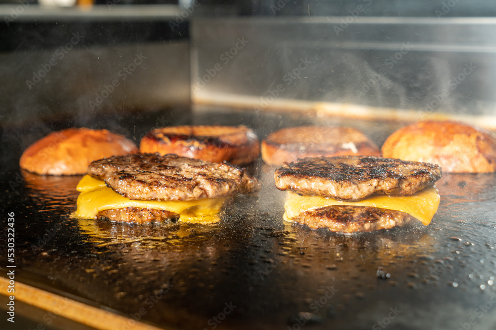Make burgers on the grill restaurant. Burgers cooking on a gas grill ...