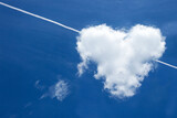 Fototapeta Kuchnia - Heart shaped clouds in blue sky with plane trace.