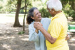© Photographielove - Cheerful active senior couple in public park together having fun.