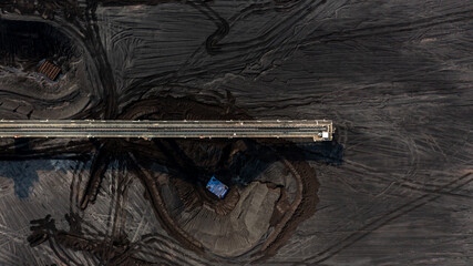 Wall Mural - Aerial top view moving belt with heap of coal next to the coal power plant, Coal mining view from above,
