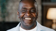 © Yuliia - Glad happy african american grandfather ethnic man unshaved elderly 60s retired confident businessman handsome mature gentlemen laughing smiling white toothy smile gaze looking at camera posing indoor