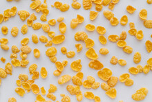 Top View Of Crispy And Yellow Corn Flakes On White Background.