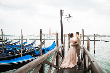 Wall Mural - Gorgeous happy couple standing close to each other and looking in eyes in Venice, Italy