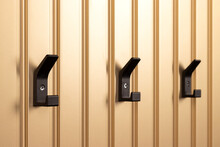 Black Modern Hangers, Coat Hooks On Golden Wall Closeup. Selective Focus