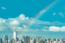 Skyline Of Taipei City In Downtown Taipei, Taiwan.bright Sun Shining Center Top And A Large Rainbow