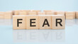 © Maks_Lab - word FEAR on wooden cubes over bright background with copy space