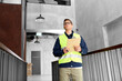 © Syda Productions - architecture, construction business and building concept - male supervisor in safety west with clipboard working at office