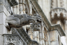 Monstrous Statue With Almost Human Features Called Gargoyle On The Historic Building