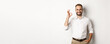 Satisfied businessman smiling and showing ok sign, approve and like something good, standing over white background