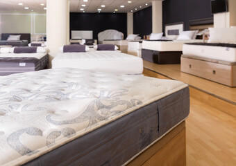 Wall Mural - Closeup of new fashionable modern stylish orthopaedic mattress on display for sale in large furniture store