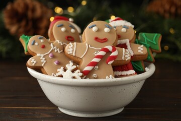 Wall Mural - Delicious homemade Christmas cookies in bowl on wooden table against blurred festive lights