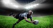 © vectorfusionart - Composition of male rugby player diving holding ball on rugby pitch