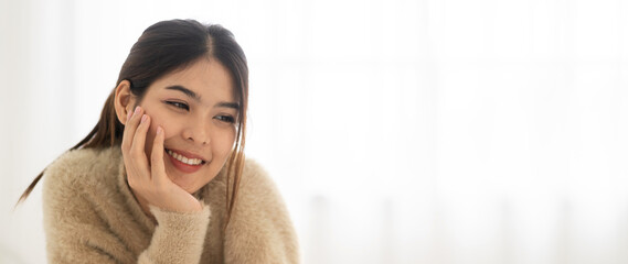 Portrait of smiling cheerful beautiful pretty asian woman clean fresh healthy white skin posing smile in pajamas clothes.Girl felling relax and enjoy time on the bed at home.asia beauty