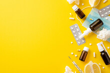 Seasonal Diseases Concept. Top View Photo Of Medicines Bottles Pills Blisters Thermometer Face Mask Crumpled Napkins And Cut Lemon On Isolated Yellow Background With Copyspace