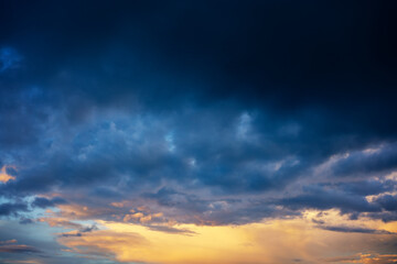 Wall Mural - Abstract beautiful nature background, bright sunset sky with storm deep blue clouds