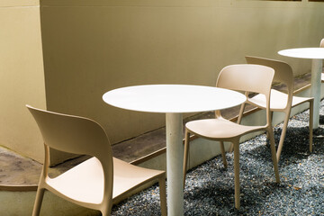 Modern white chairs and table in garden.