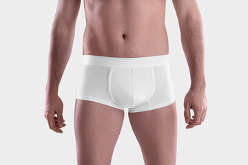 Wall Mural - Mockup of white male boxers on the athletic body of a guy, brief underwear, isolated on background, front view.