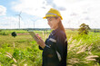© tonefotografia - a woman engineer is wearing a protective helmet on her head, using tablet Analytics engineering data..