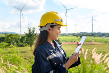 a woman engineer is wearing a protective helmet on her head, using tablet Analytics engineering data..