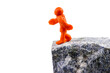 Self-made human plasticine figure walking to the edge of the abyss