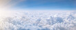 © Julija - Banner with white cumulus cloud. Over clouds. Aerial view from airplane window.
