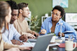 © Seventyfour - African businesswoman discussing alternative energy with her colleagues at table at meeting