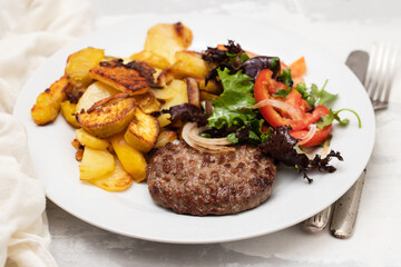 Wall Mural - three fried ground meat with fried potato and salad on white plate