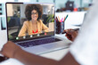 © vectorfusionart - Midsection of african american businesswoman making laptop video call with biracial female colleague