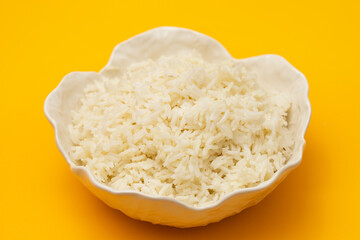 Wall Mural - white boiled rice in beautiful bowl on yellow